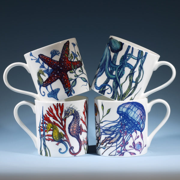 Set of four Bone china white mugs featuring hand drawn Reef designs stacked showing each design.One Starfish,Octopus,Seahorse and a Jellyfish in our bright reef colours