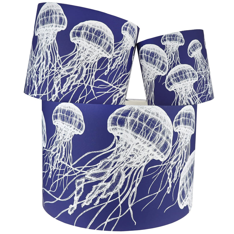 Our Classic  jellyfish white  design on a Navy background.The lampshades are shown in a stack of three showing all three sizes.