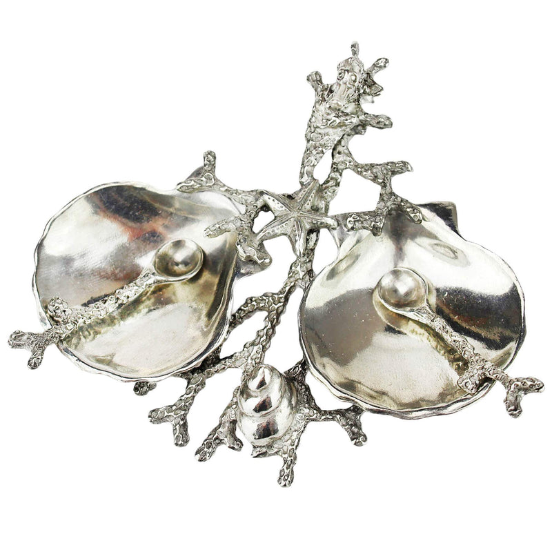 Close up Aerial view of Pewter Shell & Coral Condiment Set consisting of two pewter scallop shaped bowls held together by a sea coral design pewter structure.It has a starfish, tiny seahorse and a shell on the branches
