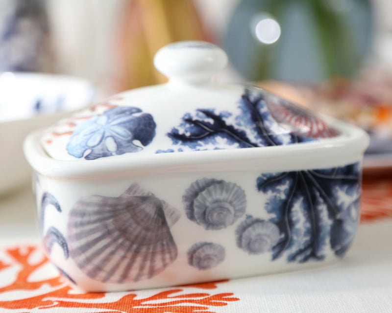 Butter dish in our Beachcomber range,with shells,seaweed and other sea themed designs all over the base and the lid on a tablecloth
