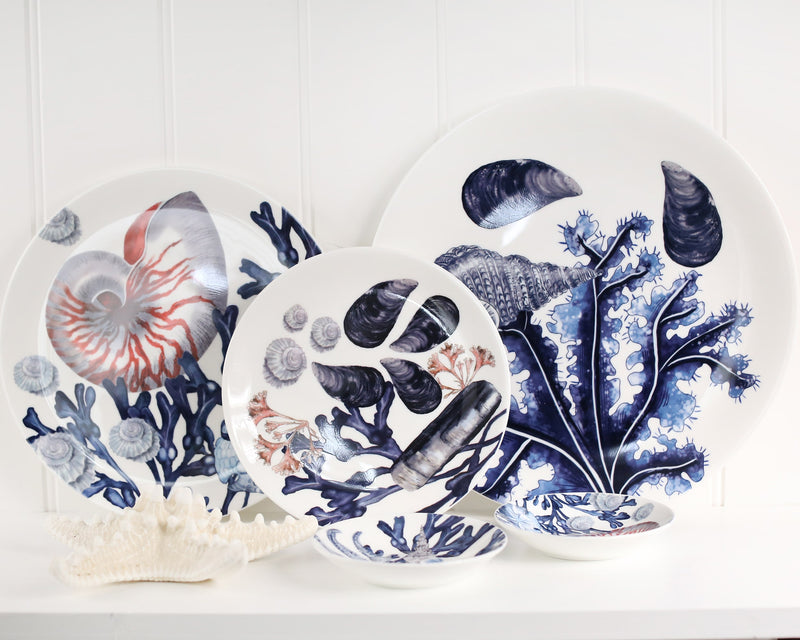 Bone china beachcomber plates leaning up against a wall,infont are a couple of the matching nibbles bowls
