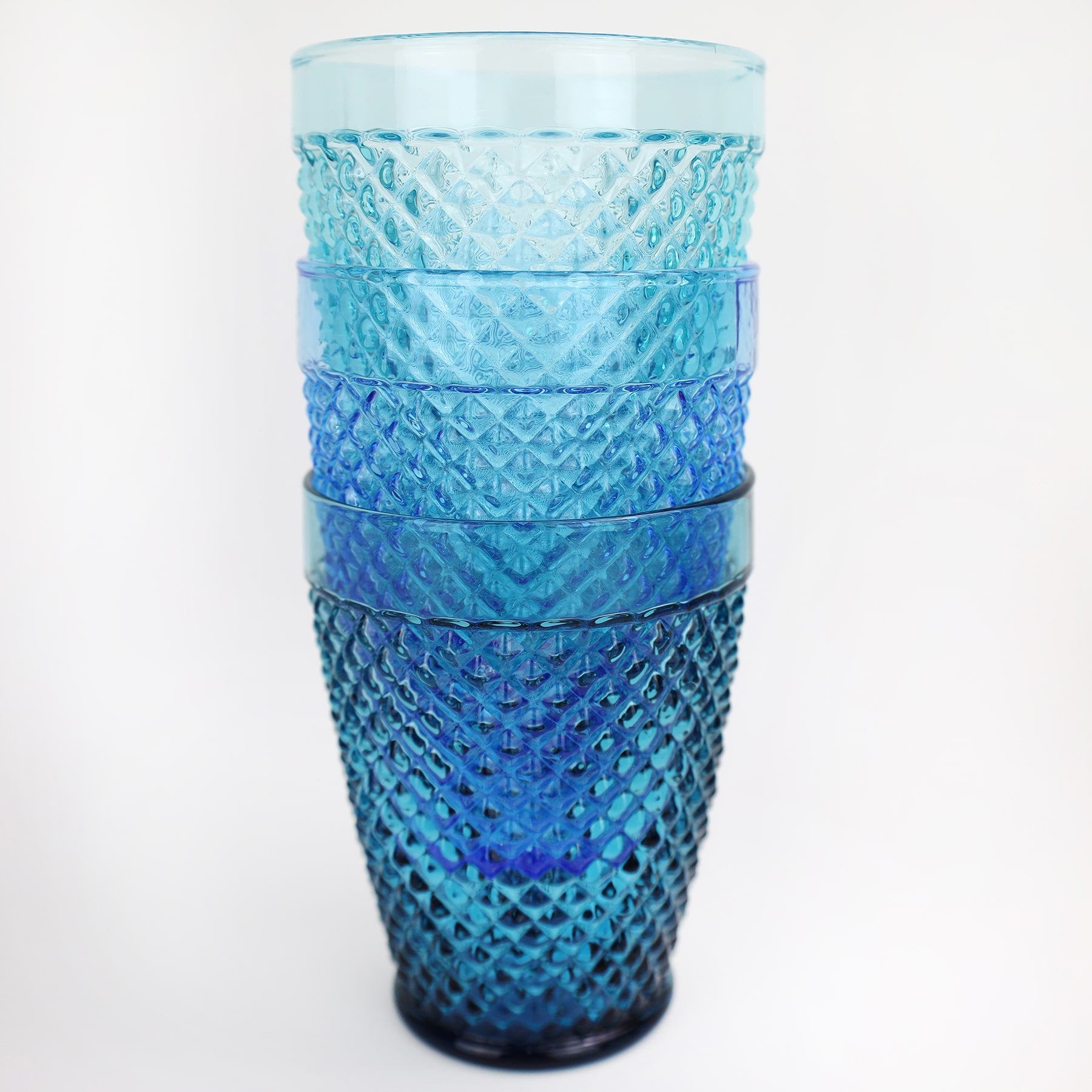 Close up of 4 stacked diamond cut patterned tumblers