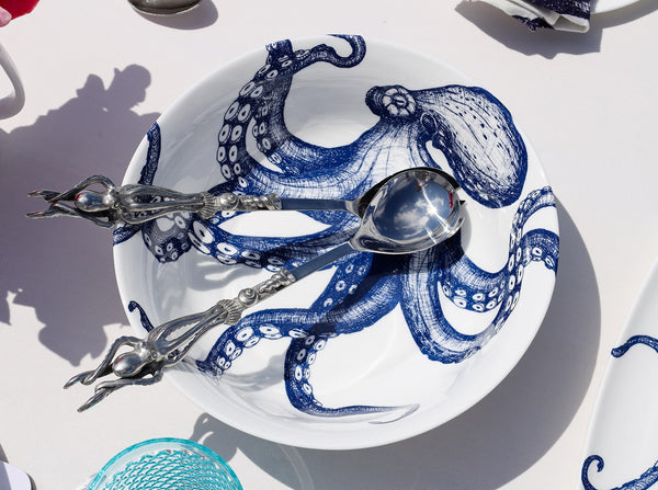 Serving bowl in Bone China in our Classic range in Navy and white in the Octopus design on a white tablecloth.In the bowl are a pair of pewter lobster salad servers,also on the table are other Cream pieces of tableware
