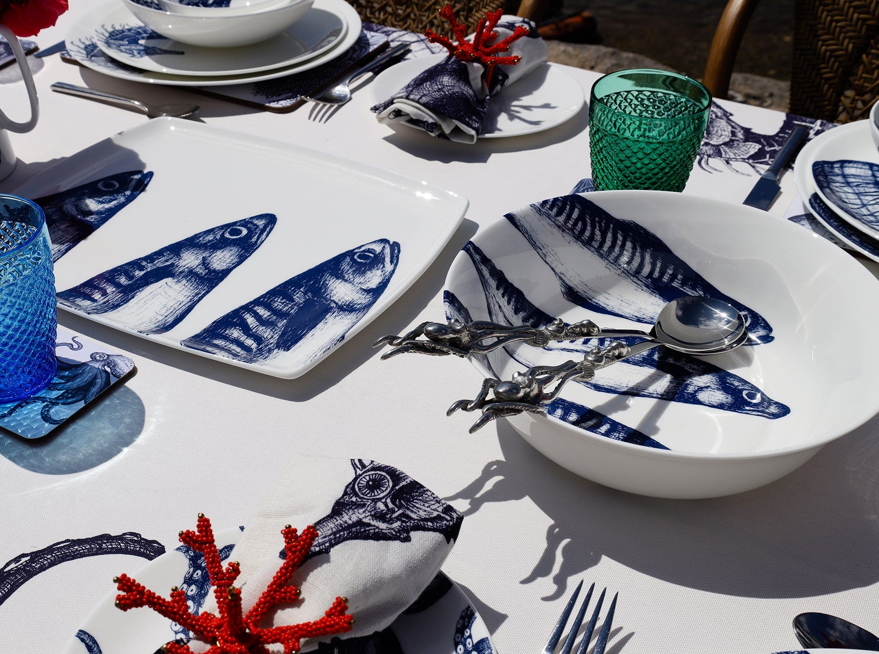 Platter in Bone China in our Classic range in Navy and white in the Mackerel design on a white tablecloth .In the background are other place settings in our classic designs and a Mackerel serving bowl with serving spoons