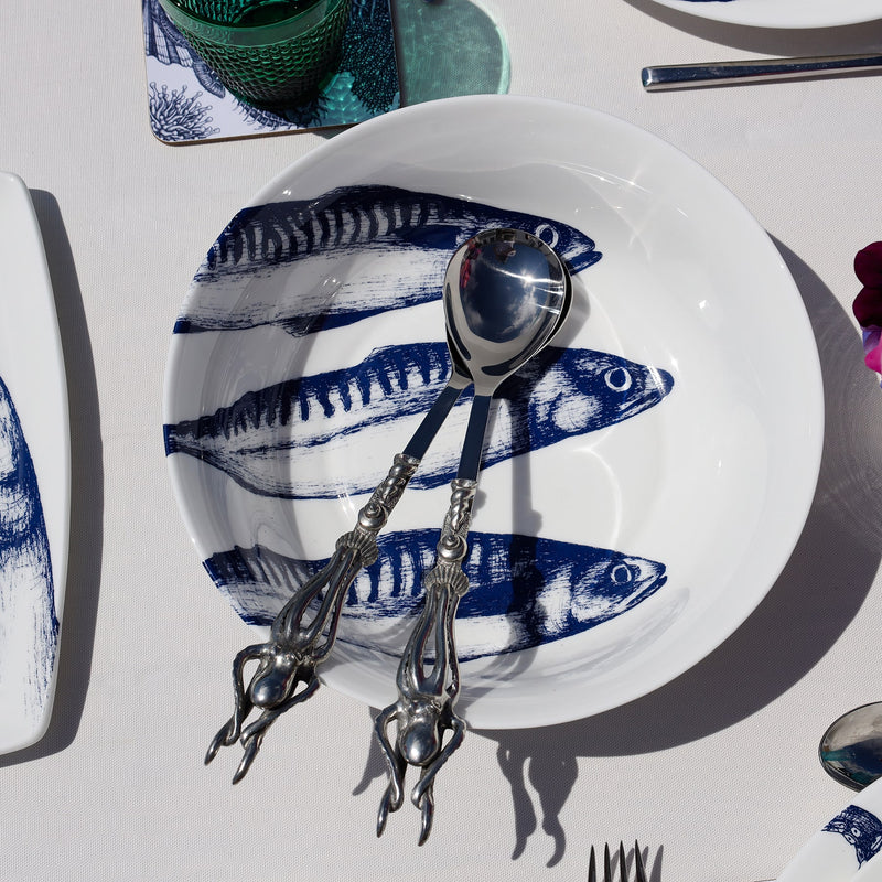 Serving bowl in Bone China in our Classic range in Navy and white in the Mackerel design on a white tablecloth.In the bowl are a pair of pewter lobster salad servers,also on the table are other Cream pieces of tableware