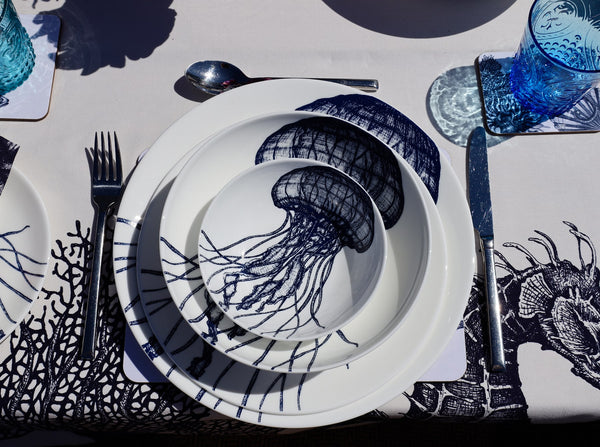 Aerial view of Bone China White plate with hand drawn illustrations of our classic Jellyfish  in Navy stacked with the large dinner plate,pasta bowl and cereal bowl