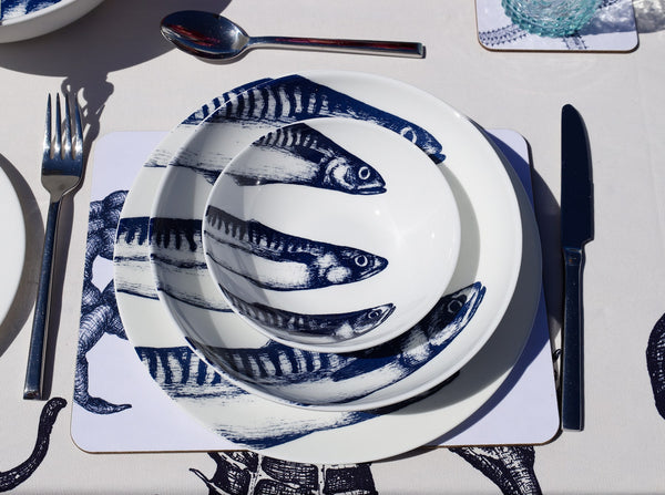Aerial view of Bone China White plate with hand drawn illustrations of our classic Mackerel Heads in Navy stacked with the pasta bowl and cereal bowl