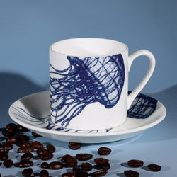 Bone China white espresso cup in hand drawn illustration in our Jellyfish design in Navy with matching saucer surrounded by coffee beans