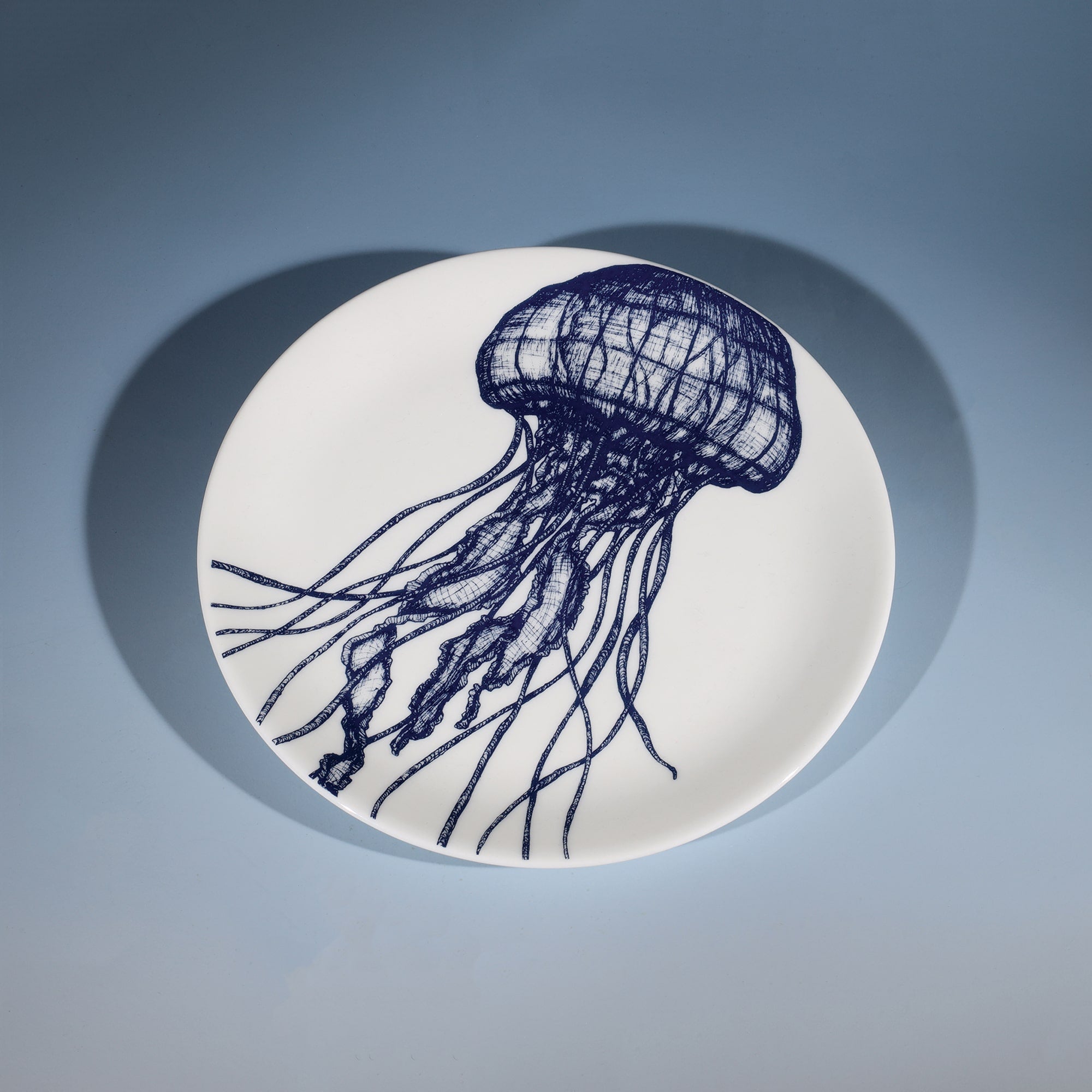 Bone China White plate with hand drawn illustrations of our Jellyfish design on a side plate in Navy