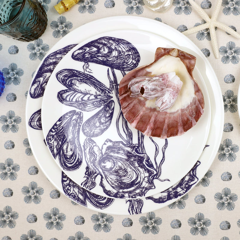 Bone china dinner plate with mussels & oyster design on a tablecloth,scallop shell placed on the top plate