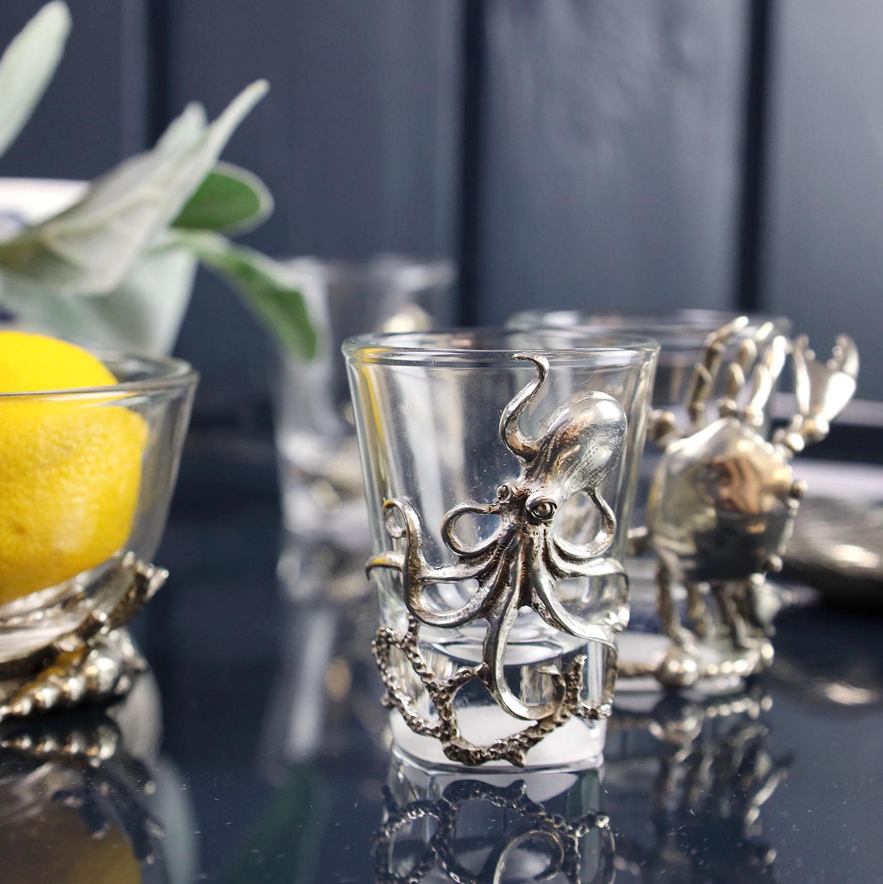 Pewter Octopus Shot Glass on a mirror table in front of a bowl with lemons in