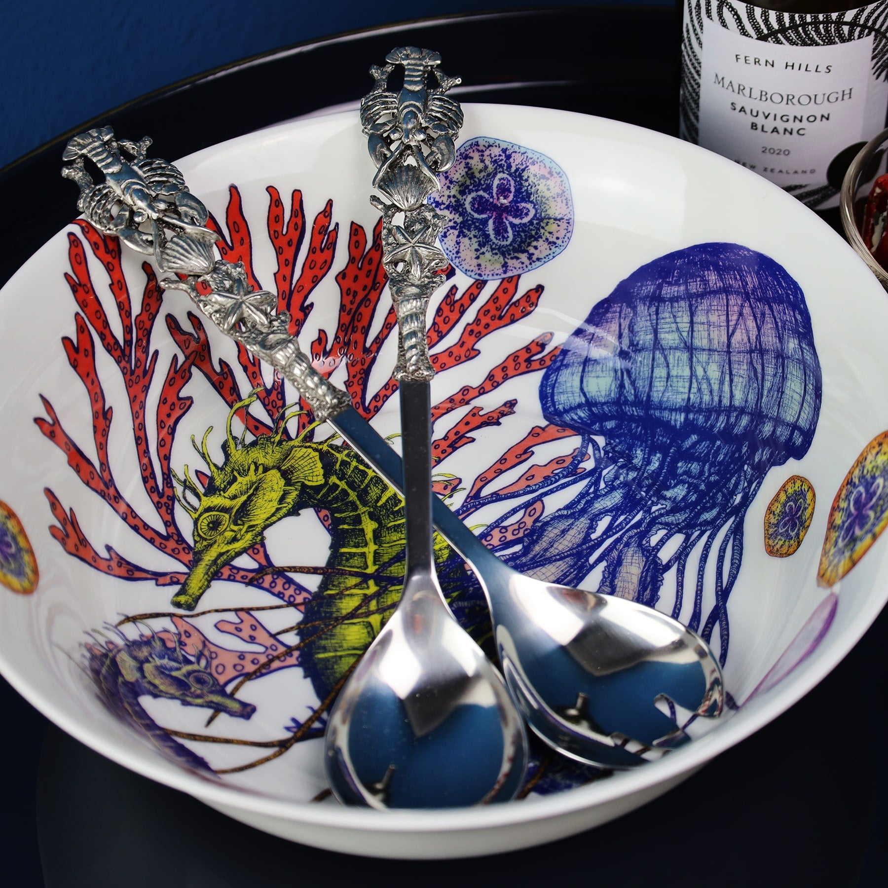 Close up of Pewter Shell & Lobster Salad Servers in a reef serving bowl 