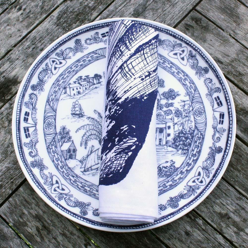Bone China White  plate with beautifully hand drawn illustrations our classic Willow design with typically Cornish scenes in Navy.On the plate ia a rolled napkin