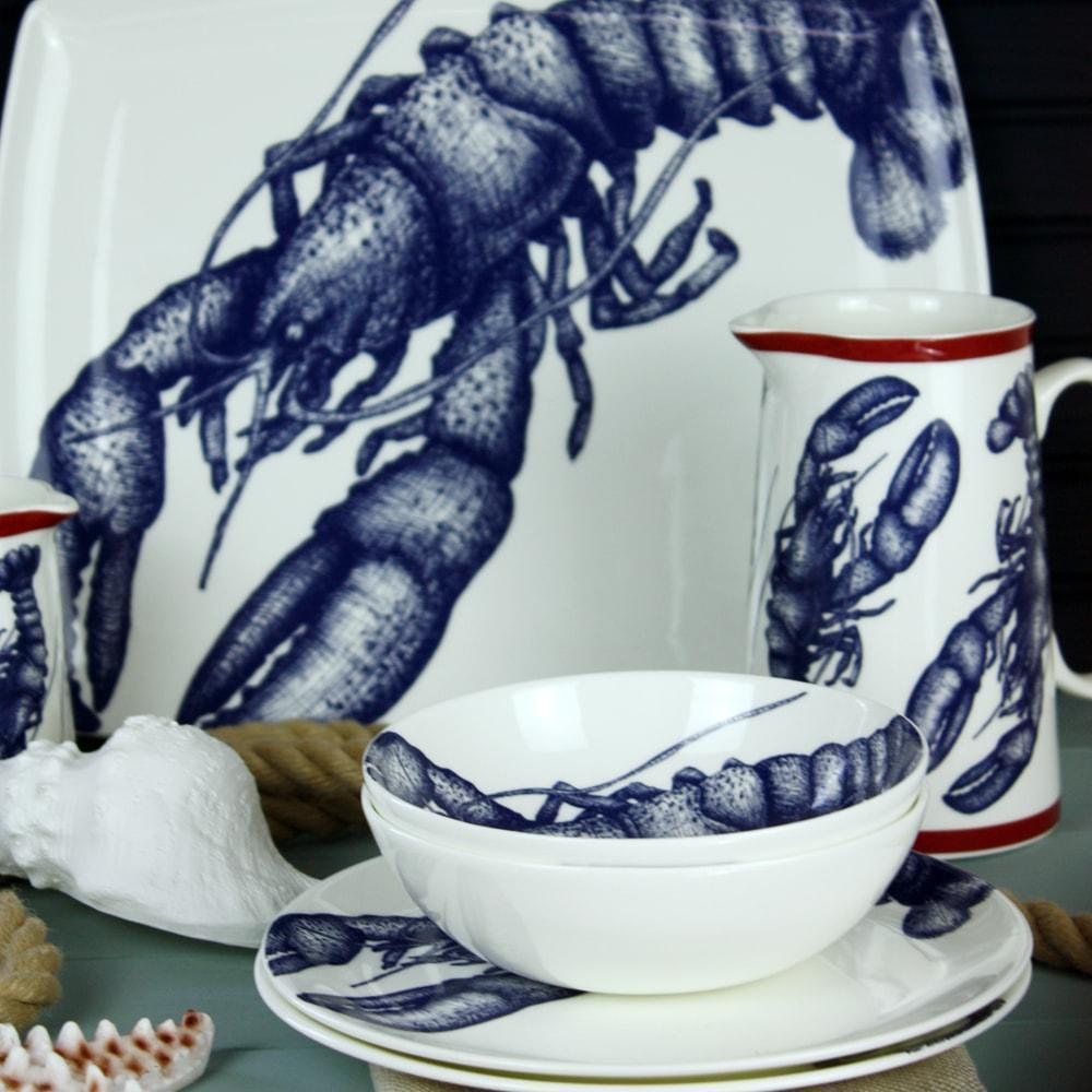 Platter in Bone China in our Classic range in Navy and white in the Lobster design on its side.In front are matching side plates and bowls and a jug also in the lobster design