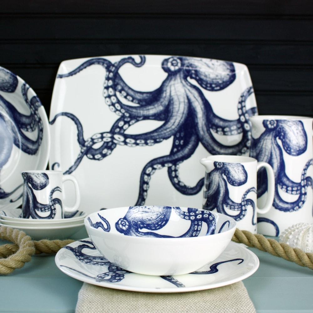 Platter in Bone China in our Classic range in Navy and white in the Octopus design on its side.In front are matching plates, bowls and a jug on the table with a winding rope on the table