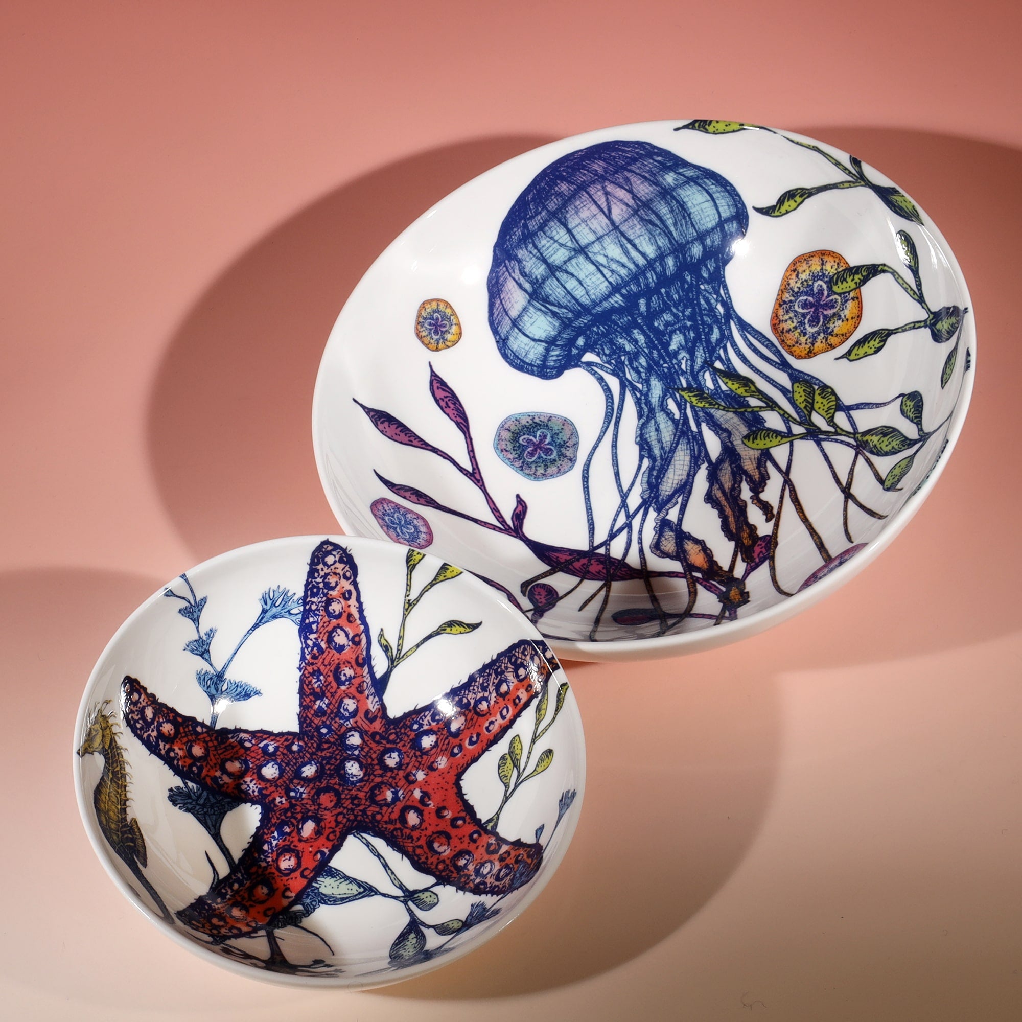 Pasta bowl in Bone China in our Reef range in Navy and white in the brightly coloured Jellyfish design,next to a matching nibbles bowl with Starfish design