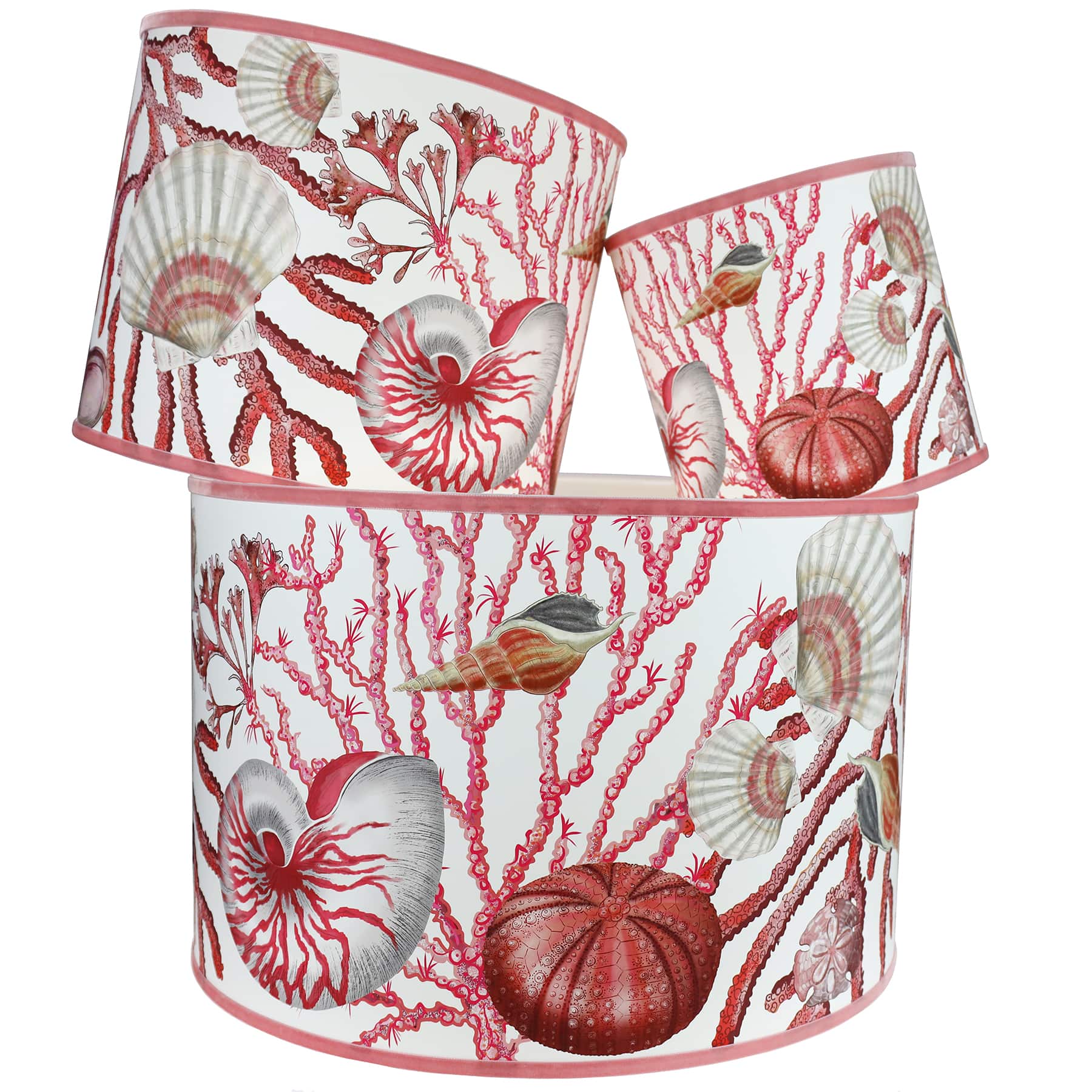 Shell Seeker Off White Shade With Shells,Seaweed,Sea Urchin and Whelks Design in pinks/whites with a pink trim on the edge of the shade.The lampshades are shown in a stack of three showing all three sizes.