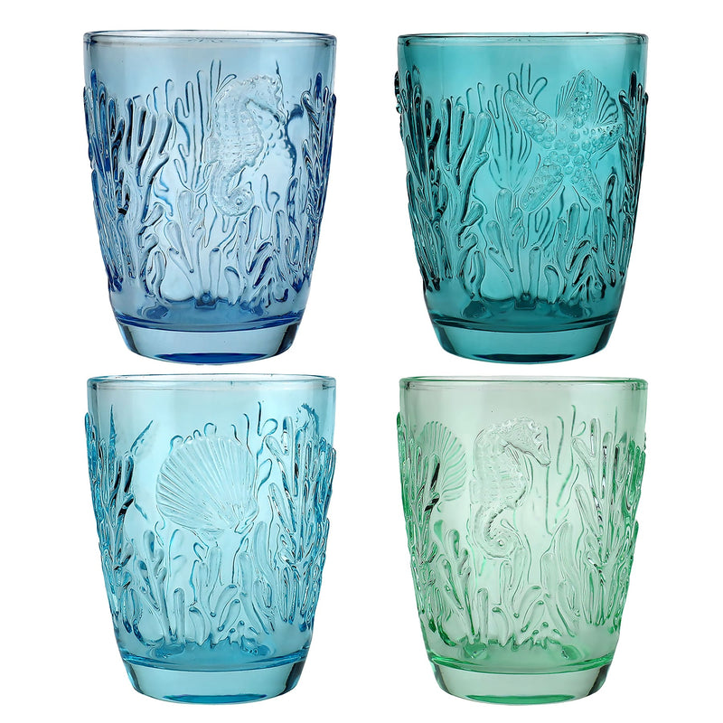 Set of four coloured tumblers with embossed sea creatures in the glass in various shades of blue