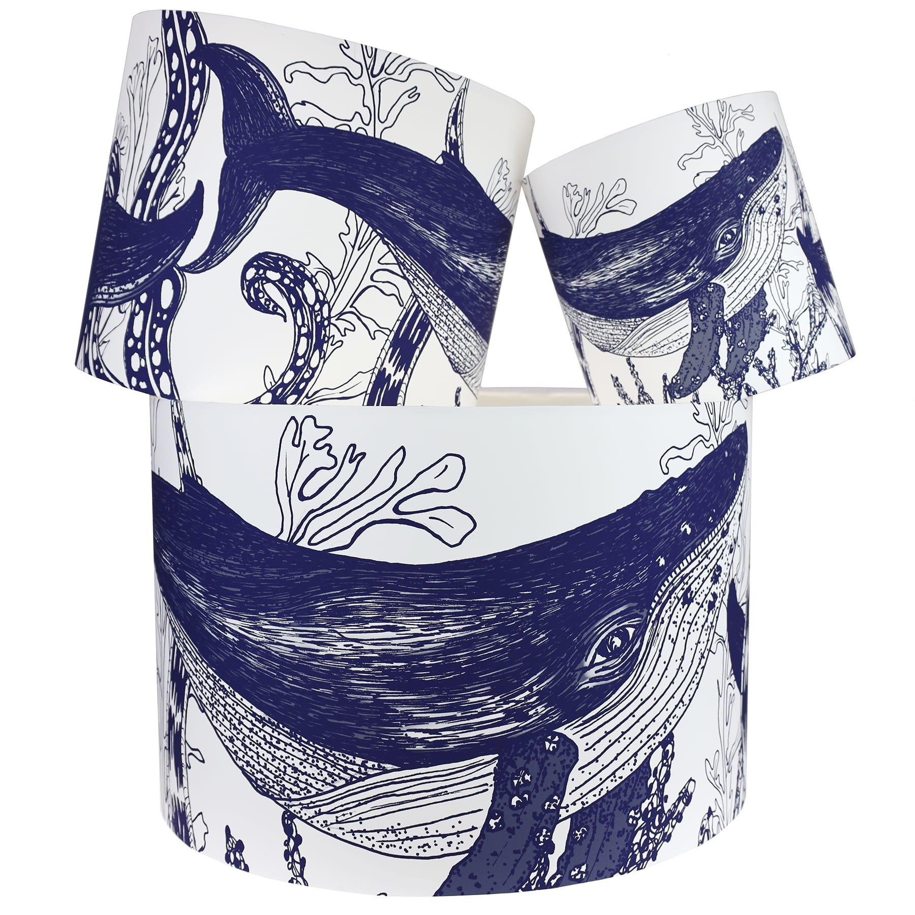 Our Classic Navy Whale design on a white background.The lampshades are shown in a stack of three showing all three sizes.